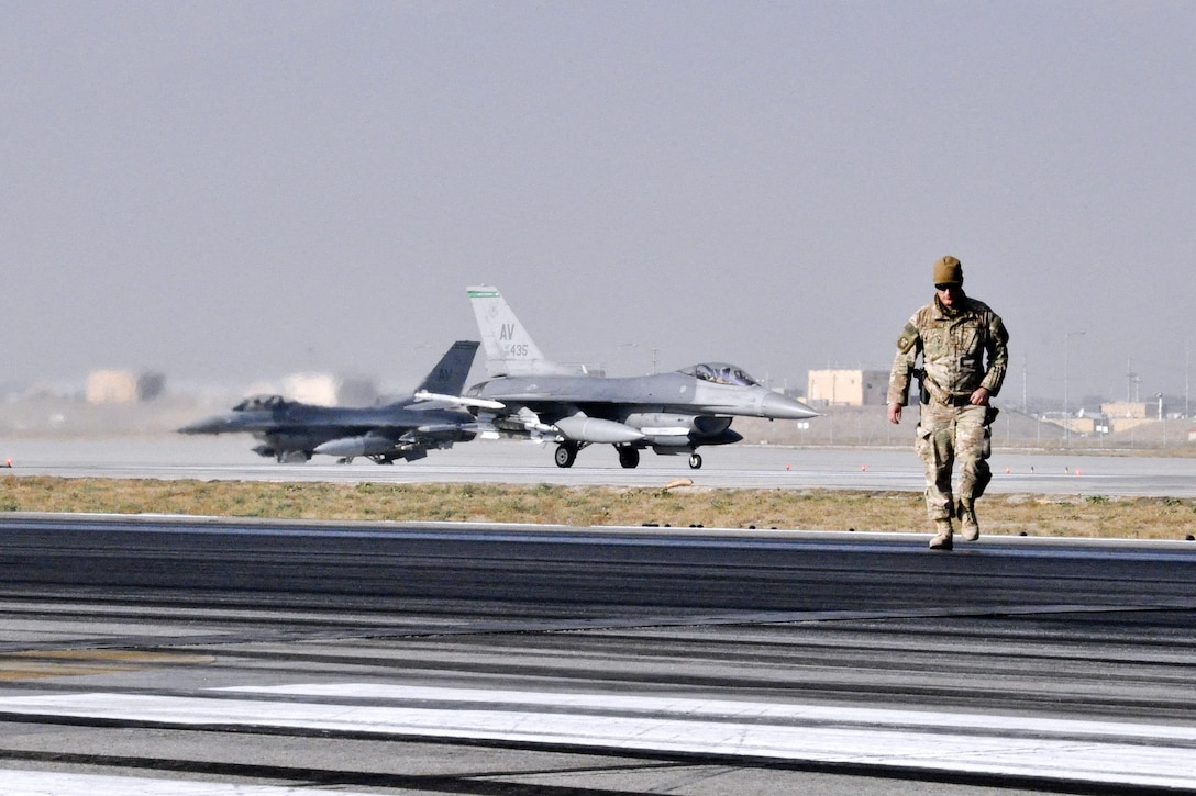 U.S. Air Force Tech. Sgt. Christopher Fitzgerald inspects the runway as rubber is removed on Bagram Airfield, Afghanistan, Oct. 22, 2015. Fitzgerald is assigned to the 577th Expeditionary Prime Base Engineer Emergency Force Squadron, deployed from Al Udeid Air Base, Qatar. U.S. Air Force photo by Tech. Sgt. Nicholas Rau