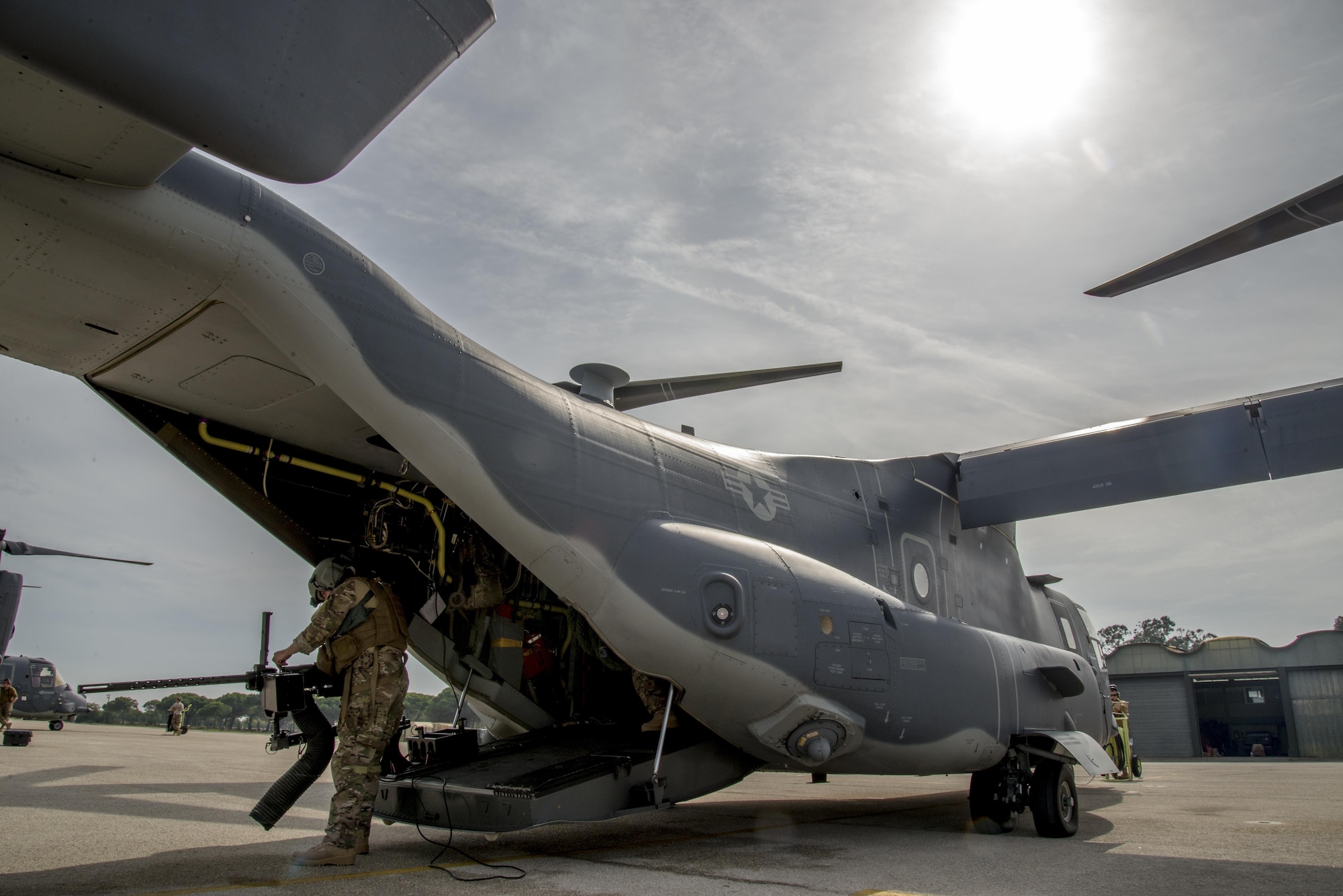A CV-22 Osprey flight engineer from the 352d Special Operations Wing performs pre-flight checks prior to liftoff from Air Base 6, Monijo, Portugal, Oct 23, 2015. The aircraft and crew traveled to Almagro, Spain where U.S. and international partners trained on fast-rope, exfiltration and infiltration procedures as part of TRIDENT JUNCTURE 15. (U.S. Air Force photo by 1st Lt. Chris Sullivan/Released)