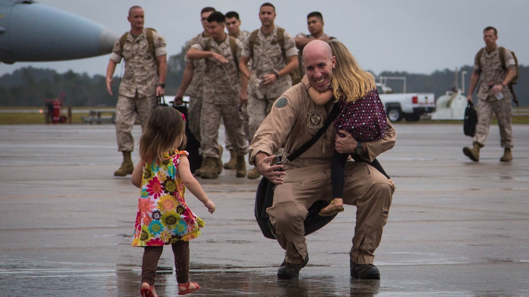 A Marine greets his children aboard Marine Corps Air Station Beaufort, South Carolina, after returning from Weapons and Tactics Instructor course Oct. 27, 2015. Marine Fighter Attack Squadron 115 and Marine All-Weather Fighter Attack Squadron 533 deployed 10 F/A-18 Hornets and 125 maintenance Marines per squadron to ensure the aircraft were ready to fly every day. The Marine is with VMFA-115, Marine Aircraft Group 31.