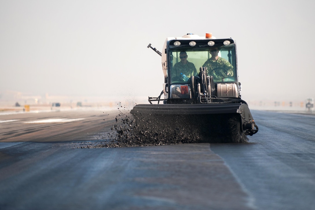 U.S. airmen remove rubber from the runway on Bagram Airfield, Afghanistan, Oct. 22, 2015. The airmen are assigned to the 577th Expeditionary Prime Base Engineer Emergency Force Squadron, deployed from Al Udeid Air Base, Qatar. U.S. Air Force photo by Tech. Sgt. Joseph Swafford