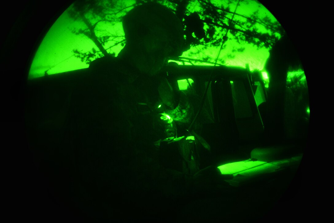 A U.S. paratrooper conducts a radio check during a night live-fire exercise as part of Exercise Rock Proof  V at Pocek Range in Postojna, Slovenia, Oct. 20, 2015. The paratrooper is assigned to the 2nd Battalion, 503rd Infantry Regiment, 173rd Airborne Brigade. Exercise Rock Proof  V is a bilateral training exercise between U.S. soldiers and the Slovenian Armed Forces, focused on small-unit tactics and building interoperability between allied forces. U.S. Army photo by Davide Dalla Massara