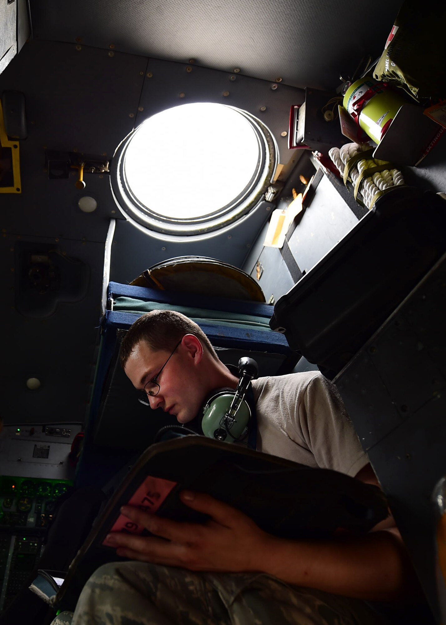 Senior Airman Phillip, 386th Expeditionary Aircraft Maintenance Squadron C-130H Hercules crew chief, goes over his pre-flight checklist at an undisclosed location in Southwest Asia, Oct. 27, 2015. During their deployment, members of the 192nd Airlift Squadron flew more than 600 airlift missions providing airlift, airdrop and reconnaissance support for Operation INHERENT RESOLVE. (U.S. Air Force photo by Staff Sgt. Jerilyn Quintanilla)
