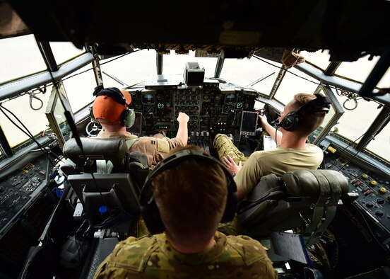 Capt. Chuck McNelley, C-130H pilot, Capt. Drew Grotbo, co-pilot, and Staff Sgt. Andrew Keterson, flight engineer, conduct pre-flight checks at an undisclosed location in Southwest Asia, Oct. 27, 2015. The flight crew is assigned to the 737th Expeditionary Airlift Squadron which provides airlift, airdrop and reconnaissance support for Operation INHERENT RESOLVE. (U.S. Air Force photo by Staff Sgt. Jerilyn Quintanilla)