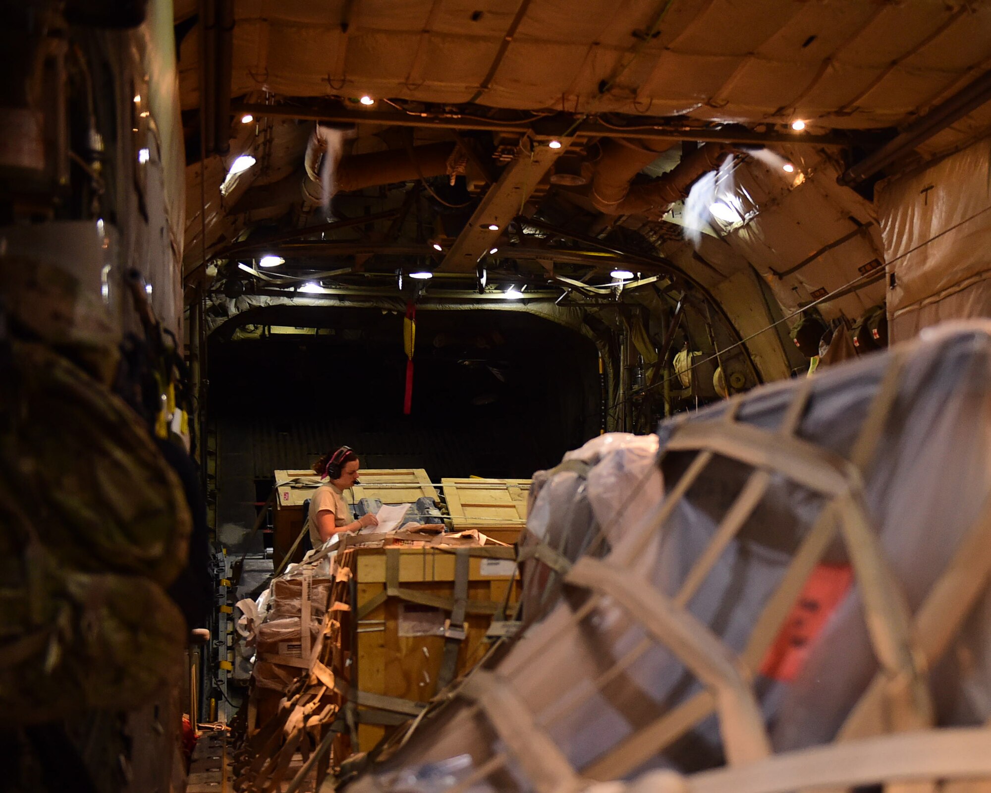 Senior Airman Erin Stewart, 737th Expeditionary Airlift Squadron loadmaster, reviews cargo paperwork onboard a C-130H Hercules at an undisclosed location in Southwest Asia, Oct. 27, 2015. Stewart and nearly one hundred members from the 192nd Airlift Squadron based out of Reno, Nevada are deployed in support of Operation INHERENT RESOLVE. (U.S. Air Force photo by Staff Sgt. Jerilyn Quintanilla)