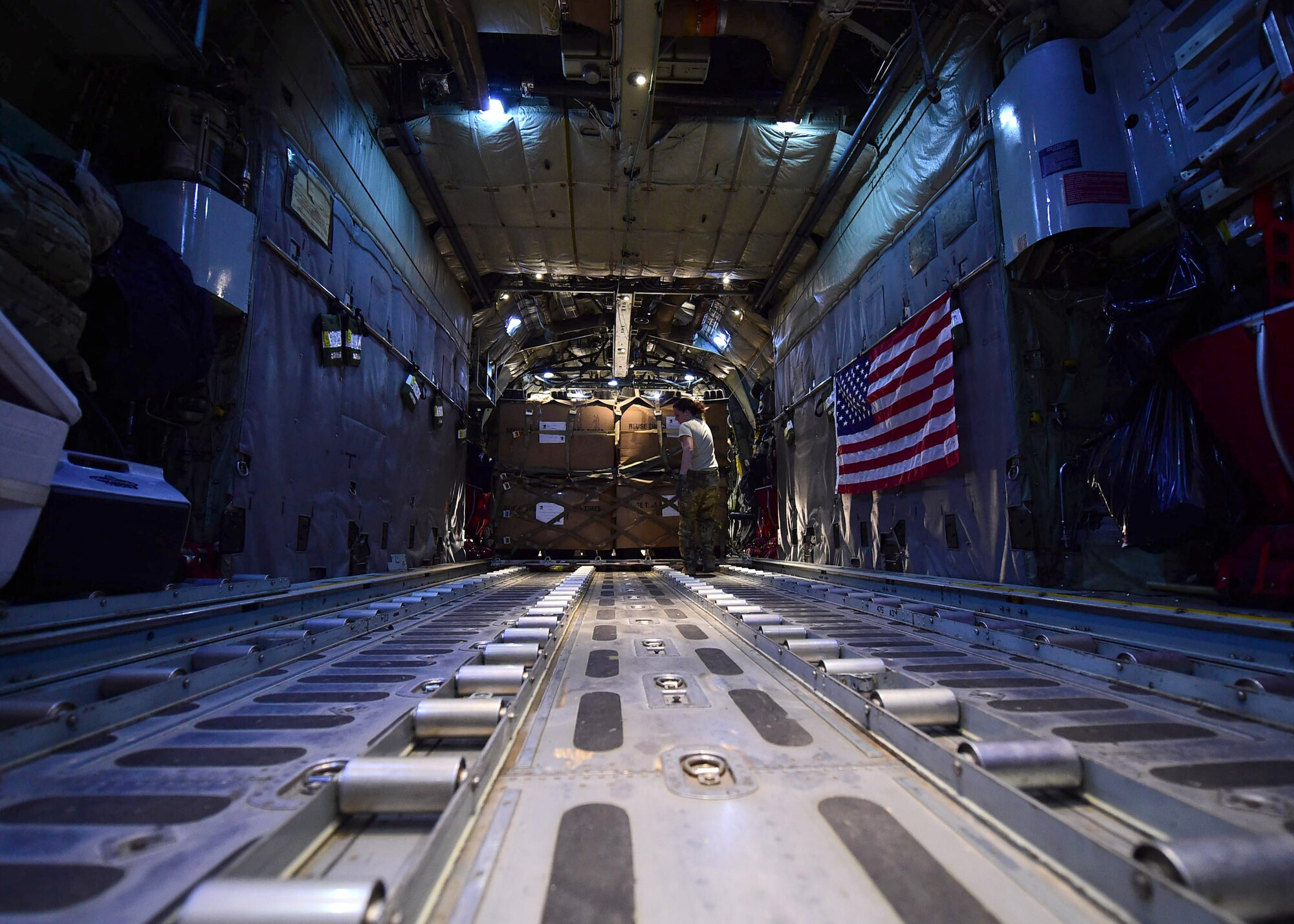 Senior Airman Erin Stewart, 737th Expeditionary Airlift Squadron loadmaster, loads cargo onboard a C-130H Hercules at an undisclosed location in Southwest Asia, Oct. 27, 2015. During their deployment, members of the 192nd Airlift Squadron flew more than 600 airlift missions. (U.S. Air Force photo by Staff Sgt. Jerilyn Quintanilla)