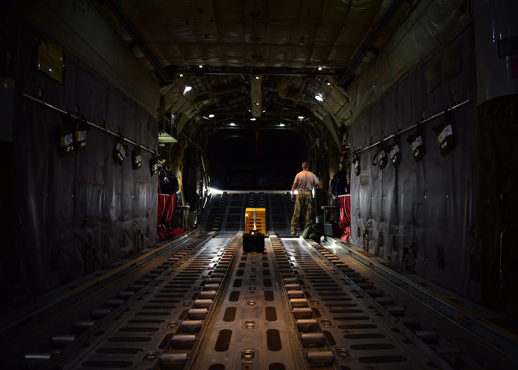 Chief Master Sgt. Thomas Glover, 737th Expeditionary Airlift Squadron loadmaster, opens the back of a C-130H Hercules at an undisclosed location in Southwest Asia, Oct. 27, 2015. Glover is one of nearly one hundred members from the 192nd Airlift Squadron based out of Reno, Nevada who are deployed in support of Operation INHERENT RESOLVE. (U.S. Air Force photo by Staff Sgt. Jerilyn Quintanilla)