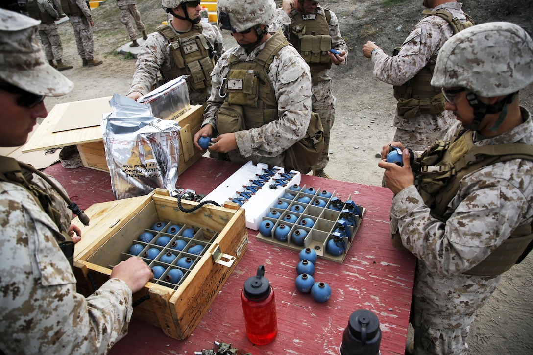 Marines attach fuses to M69 training grenades for a M67 live-fire grenade exercise during a field exercise on Camp Pendleton, Calif., Oct. 28, 2915, to prepare for deployment. The Marines are assigned to the 11th Marine Expeditionary Unit. U.S. Marine Corps photo by Cpl. Xzavior T. McNeal