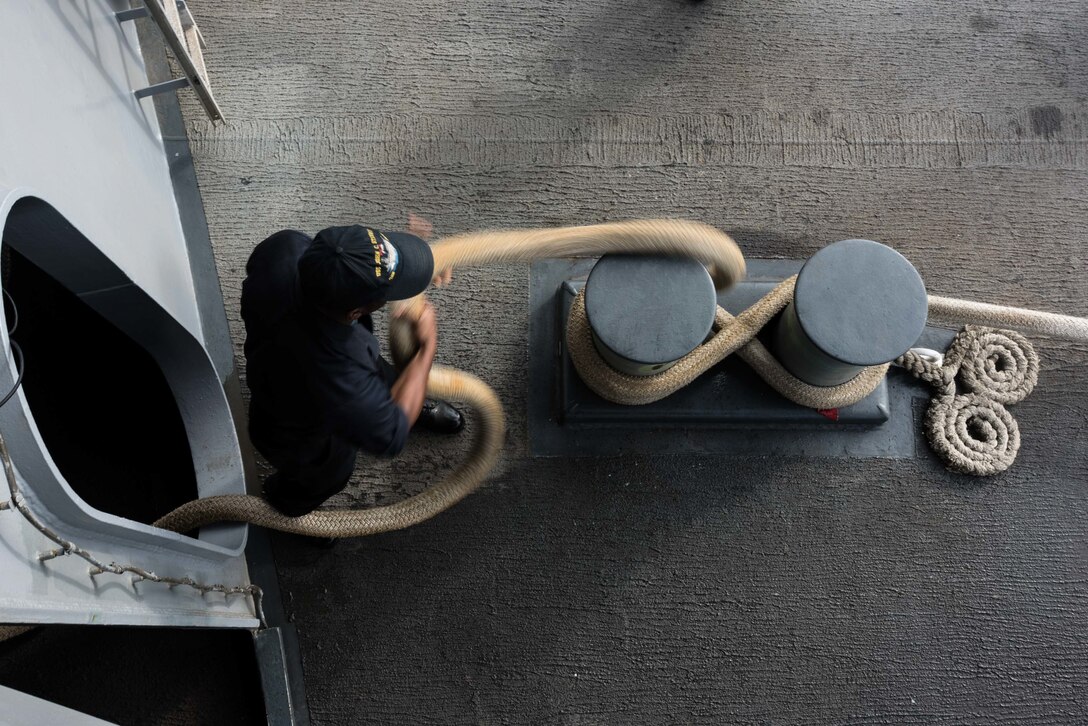 U.S. Navy Seaman Willie Cross heaves line on the fantail aboard the USS John C. Stennis in the Pacific Ocean, Oct. 19, 2015. The crew aboard the Stennis is preparing for fleet replacement squadron carrier qualifications and sustainment exercises. U.S. Navy photo by Petty Officer 3rd Class Kenneth Rodriguez Santiago