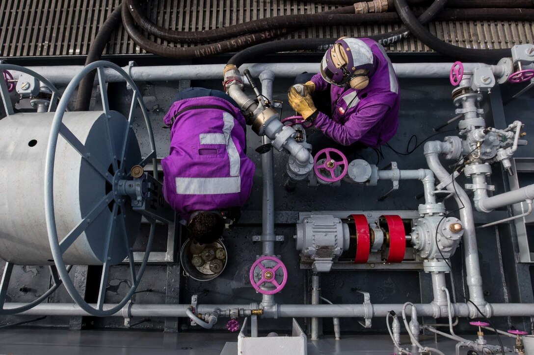 U.S. Navy Seamen Myste Shadie and Michael Kaczar take fuel samples from a fuel station on the flight deck of the USS John C. Stennis in the Pacific Ocean, Oct. 20, 2015. Shadie and Kaczar are aviation boatswain's mates (handling). U.S. Navy photo by Petty Officer 3rd Class Kenneth Rodriguez Santiago