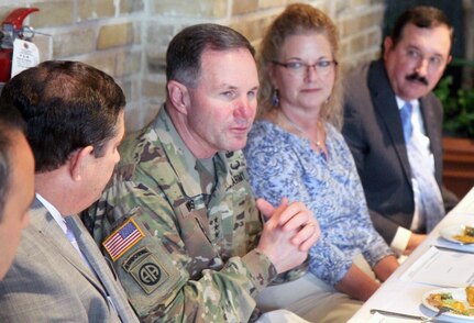Lt. Gen. Perry Wiggins (second from left), commanding general, U.S. Army North (Fifth Army) and senior Army commander for Fort Sam Houston and Camp Bullis, listens to updates on the “Adopt-A-School” program Oct. 22. He was joined at the head table by his wife, Annette, and representatives from the Fort Sam Houston, Northeast and San Antonio Independent School Districts