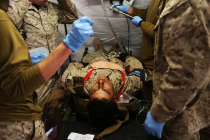 Navy Corpsmen and medical officers with Combat Logistics Battalion 11, 1st Marine Logistics Group, treat a Marine with a sucking chest wound after a simulated suicide bomber attack during Mountain Exercise 6-15 at Marine Corps Mountain Warfare Training Center, Bridgeport, Calif., Oct. 25, 2015. Engineer Platoon conducted two consecutive days of security patrols to ensure the safety of the base camp and was confronted with the challenge of a mass casualty event at the end of their patrol.