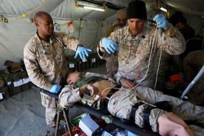 Navy Corpsmen and medical officers with Combat Logistics Battalion 11, 1st Marine Logistics Group, treat a Marine with a sucking chest wound after a simulated suicide bomber attack during Mountain Exercise 6-15 at Marine Corps Mountain Warfare Training Center, Bridgeport, Calif., Oct. 25, 2015. Engineer Platoon conducted two consecutive days of security patrols to ensure the safety of the base camp and was confronted with the challenge of a mass casualty event at the end of their patrol.
