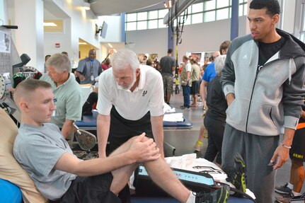 Spurs Coach Gregg Popovich and Spurs player Danny Green talk with Spc. Cruz Allen Oct. 21 at the Center for the Intrepid. 