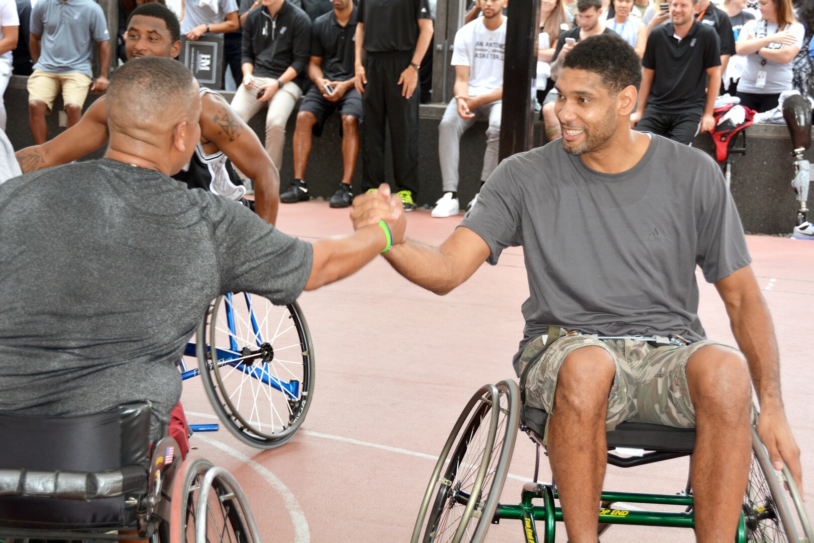 Tim Duncan congratulates a wounded warrior after a game of wheelchair basketball Oct. 21 at the Center for the Intrepid. 
