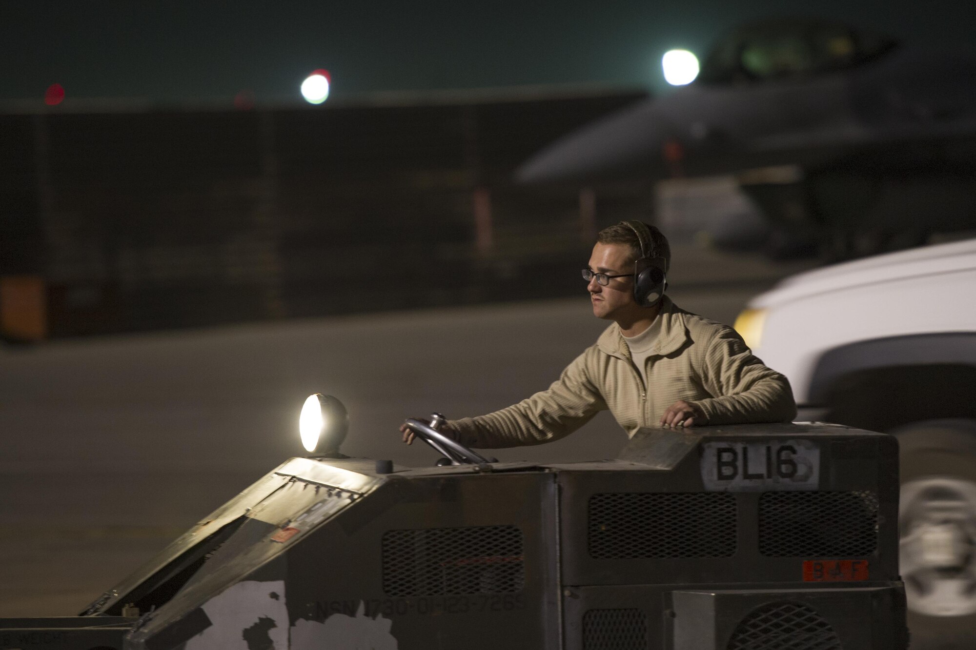 Senior Airman Brandon Goodrich, 455th Expeditionary Aircraft Maintenance Squadron aircraft armament technician, deployed from Hill Air Force Base, Utah, drives across the flight line at Bagram Airfield, Afghanistan, Oct. 28, 2015. The 421st Fighter Squadron from Hill AFB will relieve the 555th Expeditionary Fighter Squadron from Aviano Air Base, Italy this month. (U.S. Air Force photo by Tech. Sgt. Robert Cloys/Released)