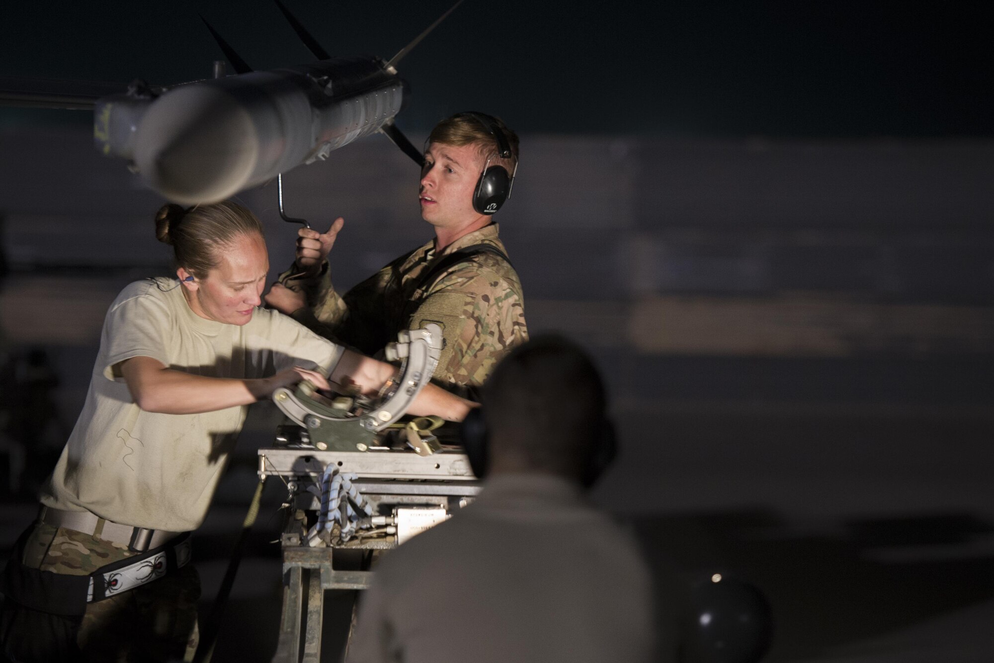 Staff. Sgt. Jeanette Martinez, 455th Expeditionary Aircraft Maintenance Squadron weapons team chief, and Senior Airman Christopher Wessig, 455th EAMXS deployed from Hill Air Force Base, Utah, load a missile onto an F-16 Fighting Falcon at Bagram Airfield, Afghanistan, Oct. 28, 2015. The 421st Fighter Squadron from Hill AFB will relieve the 555th Expeditionary Fighter Squadron from Aviano Air Base, Italy this month. (U.S. Air Force photo by Tech. Sgt. Robert Cloys/Released)