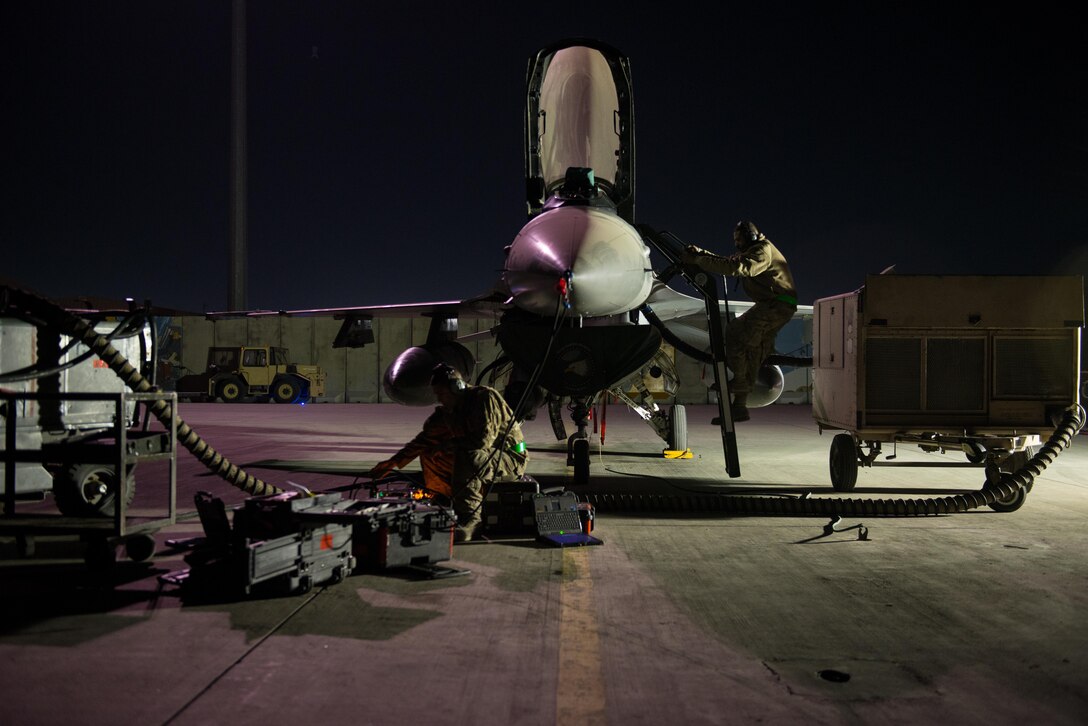 Tech. Sgt. Jesus Menacho, 455th Expeditionary Aircraft Maintenance Squadron, deployed from Aviano Air Base, Italy, climbs out of an F-16 Fighting Falcon while preforming maintenance at Bagram Airfield, Afghanistan, Oct. 28, 2015. The 555th Expeditionary Fighter Squadron will re-deploy and turn over their combat airpower mission to the 421st Fighter Squadron from Hill Air Force Base, Utah this month. (U.S. Air Force Photoby Tech. Sgt. Joseph Swafford/Released)
