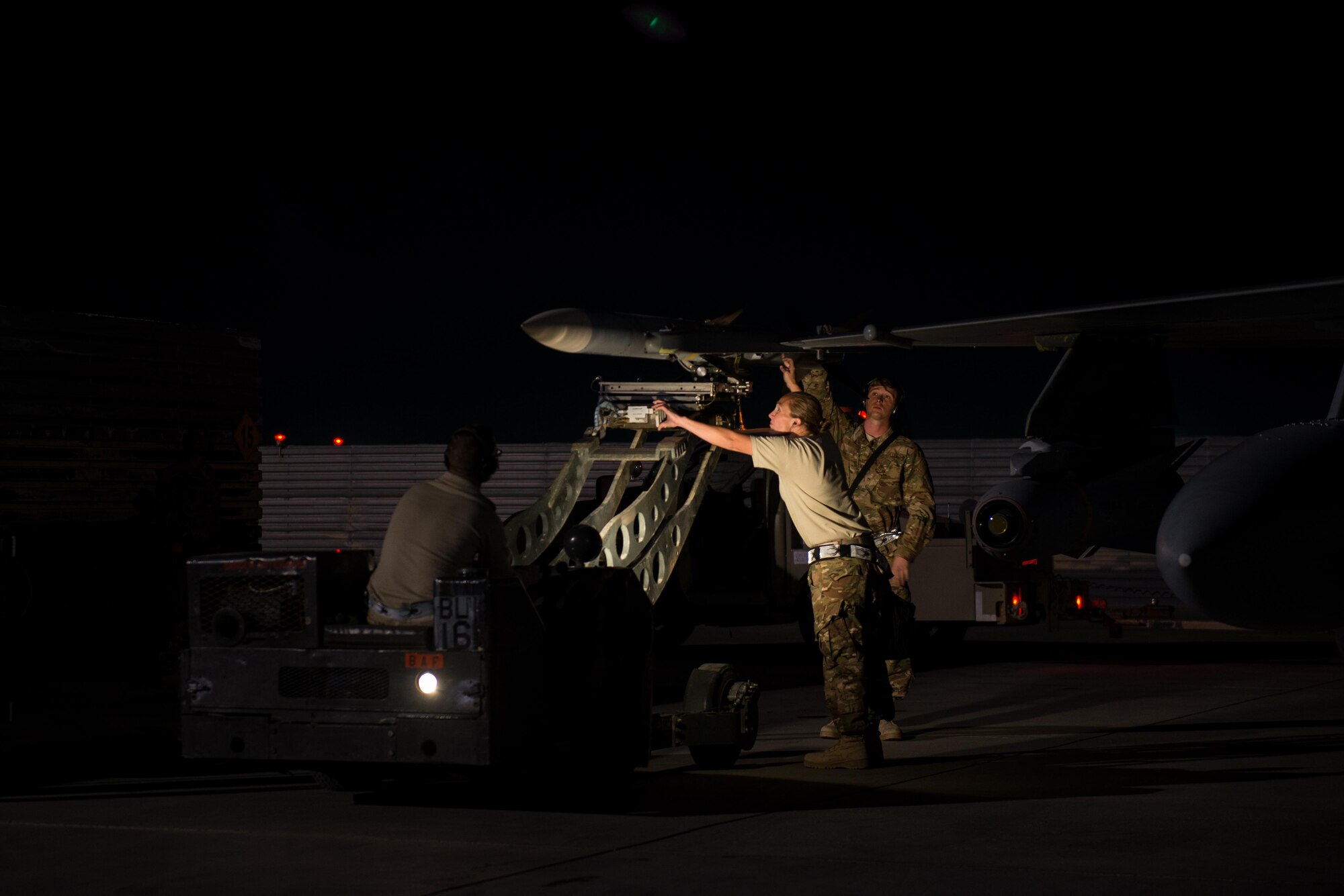 Airmen with the 455th Expeditionary Aircraft Maintenance Squadron, deployed from Hill Air Force Base, Utah, load an AIM-120 Advanced Medium-Range Air-to-Air Missile onto an F-16 Fighting Falcon aircraft at Bagram Airfield, Afghanistan, Oct. 28, 2015. The 421st Fighter Squadron will relieve the 555th Fighter Squadron from Aviano Air Base, Italy this month. (U.S. Air Force Photo by Tech. Sgt. Joseph Swafford/Released)