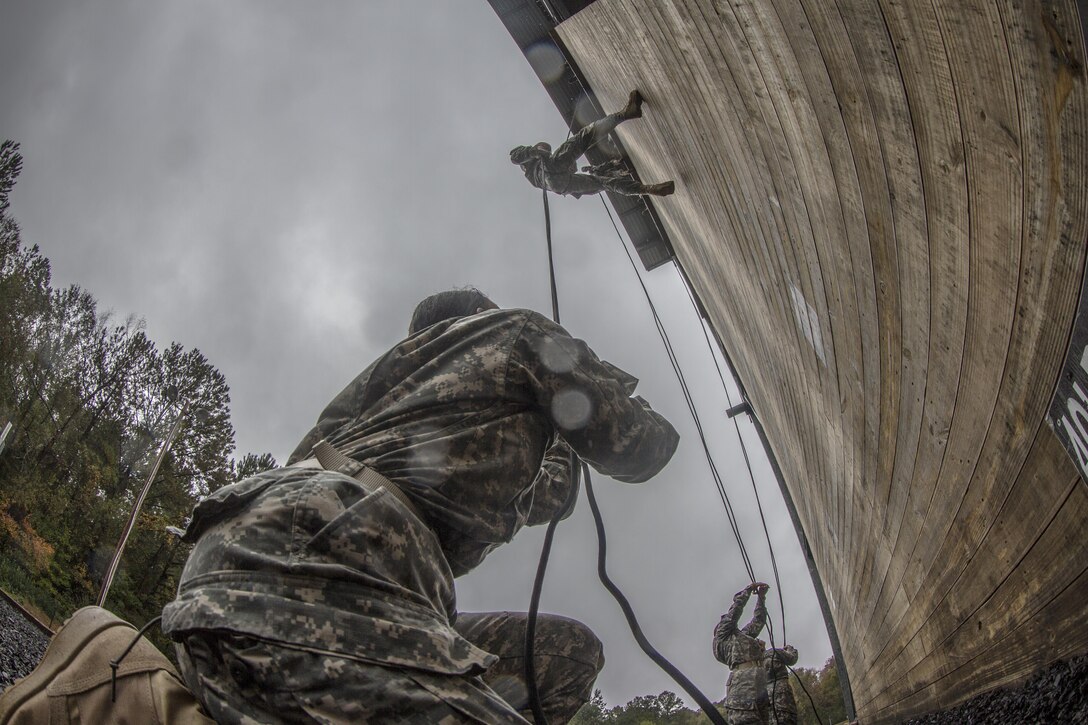 Pvt. Alisa Hamilton, E Company, 2nd Battalion, 39th Infantry Regiment, stops a Soldier repelling down the 40-foot wall from falling at Victory Tower on Fort Jackson, S.C., Oct. 28, 2015. The Soldier on belay serves as a safety for the Soldier repelling. In the event of a free-fall, the belay will pull straight down on the rope to stop the repeller almost instantly. (U.S. Army photo by Sgt. 1st Class Brian Hamilton)