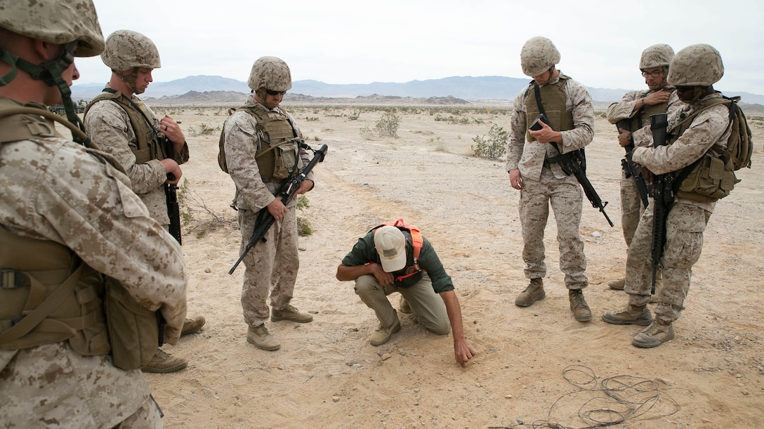 An instructor lays out a plan of attack during first responder's training with Marines from General Support Company, Combat Logistics Battalion 2, during Integrated Training Exercise 1-16 aboard Marine Corps Air Ground Combat Center Twentynine Palms, Calif., Oct. 25, 2015. Marines demonstrate core essential tasks and conduct offensive and defensive stability operations throughout ITX.
