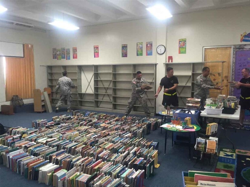 Soldiers of the 613th MP Company volunteered their time to help a local school clear the library in order to initiate a remodeling project on Oct. 13.