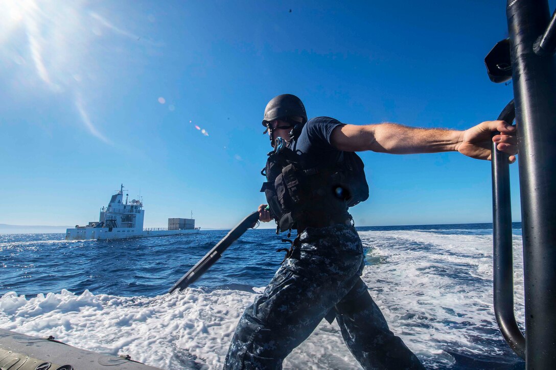 Navy Petty Officer 2nd Class Arren Halfacre prepares to board a vessel during a training exercise for the crew of dock landing ship USS Harpers Ferry in the Pacific Ocean, Oct. 26, 2015. The ship is participating in a training exercise with other units to test their ability to effectively respond to events and perform as an integrated unit. Halfacre is a bostswain's mate. U.S. Navy photo by Petty Officer 3rd Class Zachary Eshleman