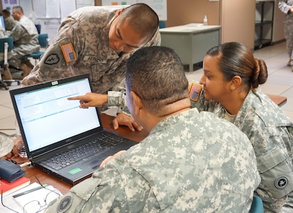 Spc. Triay Torres (right), works with Sgt. Neil Ferido and Staff Sgt. Peter Braithwaite (left) to plan a response to one of the support operations scenarios during the 311th Sustainment Command (Expeditionary) Command Post Exercise – Functional at Camp Parks, Calif., 19 Sept. The CPX-F uses a closed computer network, to simulate the operation of a command post within a simulated theater of operation, complete with inputs and feedback from notional higher, lower, adjacent, and adversary units. (U.S. Army Photo courtesy of Spc. Ivanova Jimenez 311th ESC)