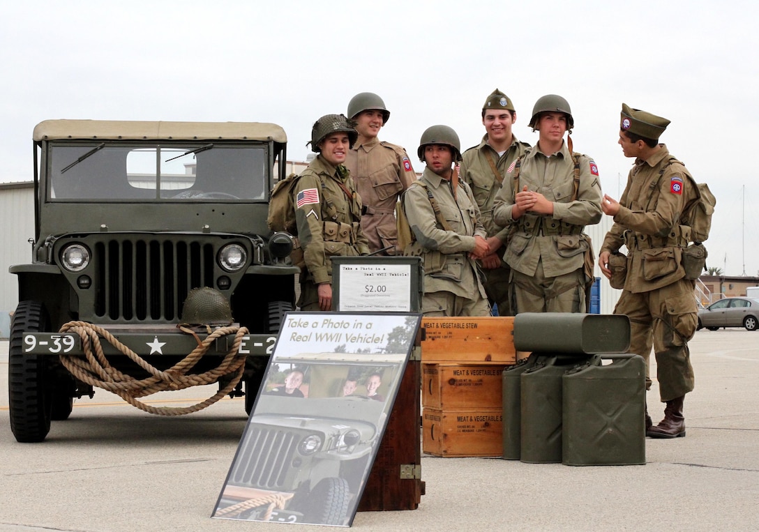 A group of WWII re-enacters and their vehicle at the 14th Annual Wings, Wheels, Rotors and Expo at Joint Forces Training Base Los Alamitos, Calif., Oct. 25, 2015. The Wings, Wheels, Rotors and Expo, produced by the Los Alamitos Area Chamber of Commerce, features hundreds of hot rods and exotic cars, helicopters, airplanes and vintage warplanes on display combined with local vendors, great food, and exhibits from law enforcement agencies and the military.