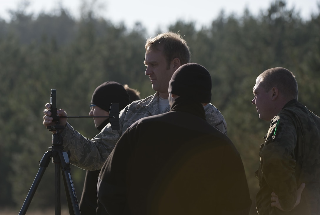 Master Sgt. Stephen Nelson, a 435th Contingency Response Group air traffic controller, uses a kestrel to obtain wind speeds and direction during Aviation Detachment 16-1 Oct. 27, 2015, at Powdiz Air Base, Poland. During the flying training deployment, U.S. and Polish airmen worked together to relay weather data to their aircrews to ensure they had the most accurate information prior to airdropping container delivery systems. (U.S. Air Force photo/Senior Airman Damon Kasberg)