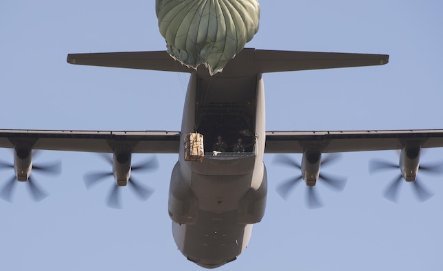 A container delivery system airdrops from a C-130J Super Hercules assigned to the 37th Airlift Squadron Oct. 27, 2015, at Powdiz Air Base, Poland. The drop was performed during Aviation Detachment 16-1, a flying training deployment that helps crews maintain their readiness and interoperability with NATO allies. (U.S. Air Force photo/Senior Airman Damon Kasberg)