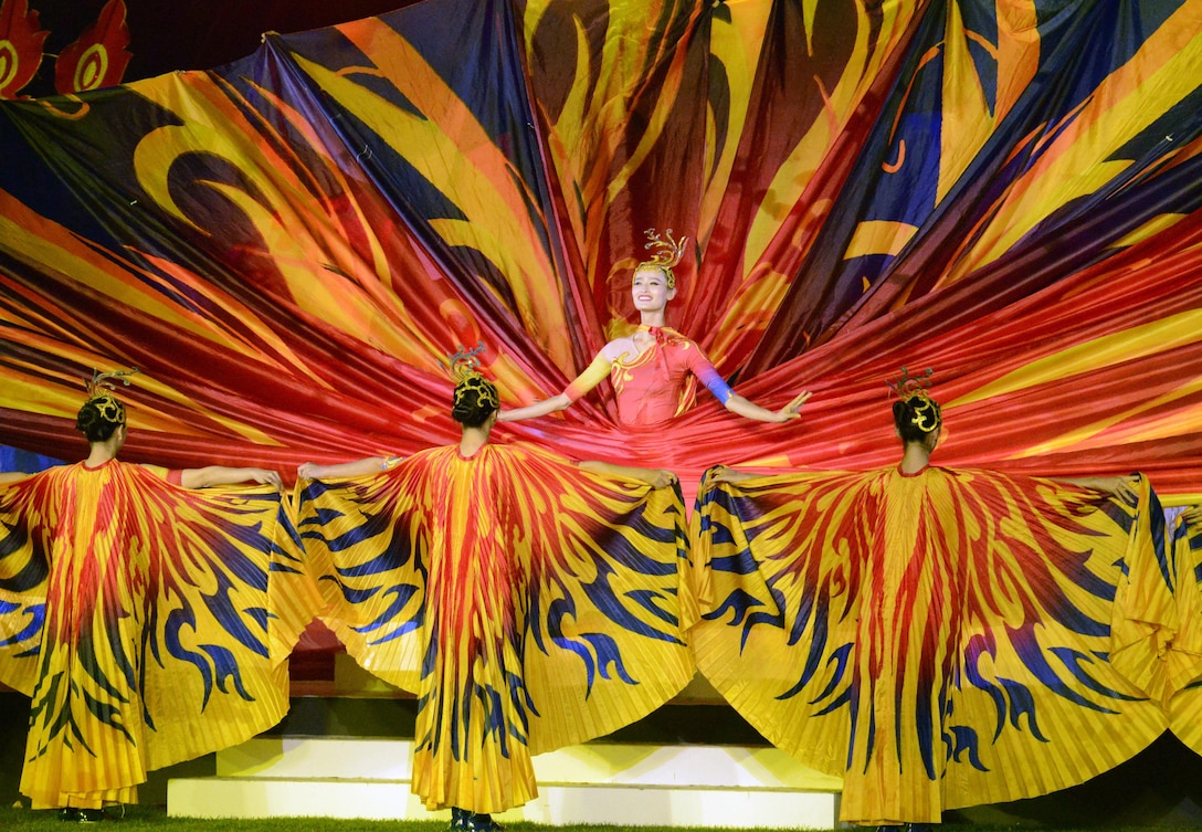 Dancers depict peacocks, butterflies and blossoms with the tapestry they twirl in a dance previewing the culture of Wuhan, capital city of central China's Hubei province, where the next CISM World Games will be held in 2019. The dance was part of closing ceremonies for the 6th CISM World Games in MunGyeong, South Korea, Oct. 11, 2015.
