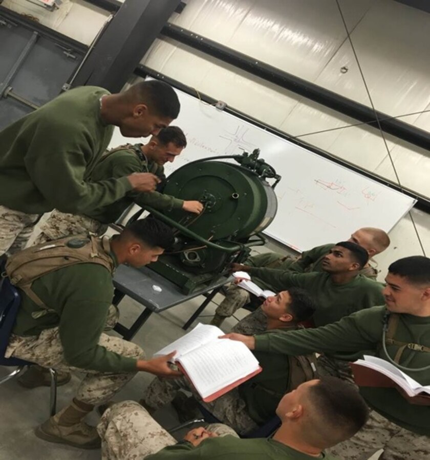 Sgt Wennberg, a water support supply technician attached to Marine Corps Engineer School, gives a class on operating and repairing bare base shower facilities to Basic Water Support Technician course 1-16 (BWST 1-16) aboard Camp Lejeune, North Carolina.  This portion of the course covers M-80 water heaters, water supply pumps, drainage pumps and shower schedules.  

