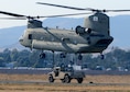 Airmen from the 60th Aerial Port Squadron and members of the Army National Guard&#39;s 49th Police Brigade practice loading and sling loading vehicles on a CH-47 Chinook cargo helicopter Oct. 14, 2015, at Travis Air Force Base, Calif. The units also practiced nighttime operations in total darkness with the aid of night vision goggles. (U.S. Air Force photo/T.C. Perkins Jr.) 