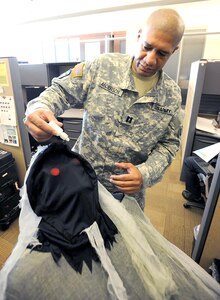 Capt. Nolan Anderson, a medical planner with U.S. Army South, attempts to help the Galleon Ghoul by administering eye drops to the ghoul’s irritated red eyes at the Old BAMC/U.S. Army South headquarters on Fort Sam Houston.