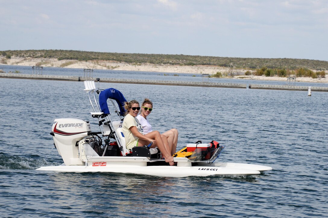 Cydney Gray, front, and Liz Rogers test one of the new catamaran style watercrafts at Southwinds Marina on Oct. 16, 2015. This watercraft can reach speeds of up to 25 mph and can be rented for $20 an hour or $100 for a day (prices include gasoline). (U.S. Air Force photo by Airman 1st Class Brandon May)(Released)