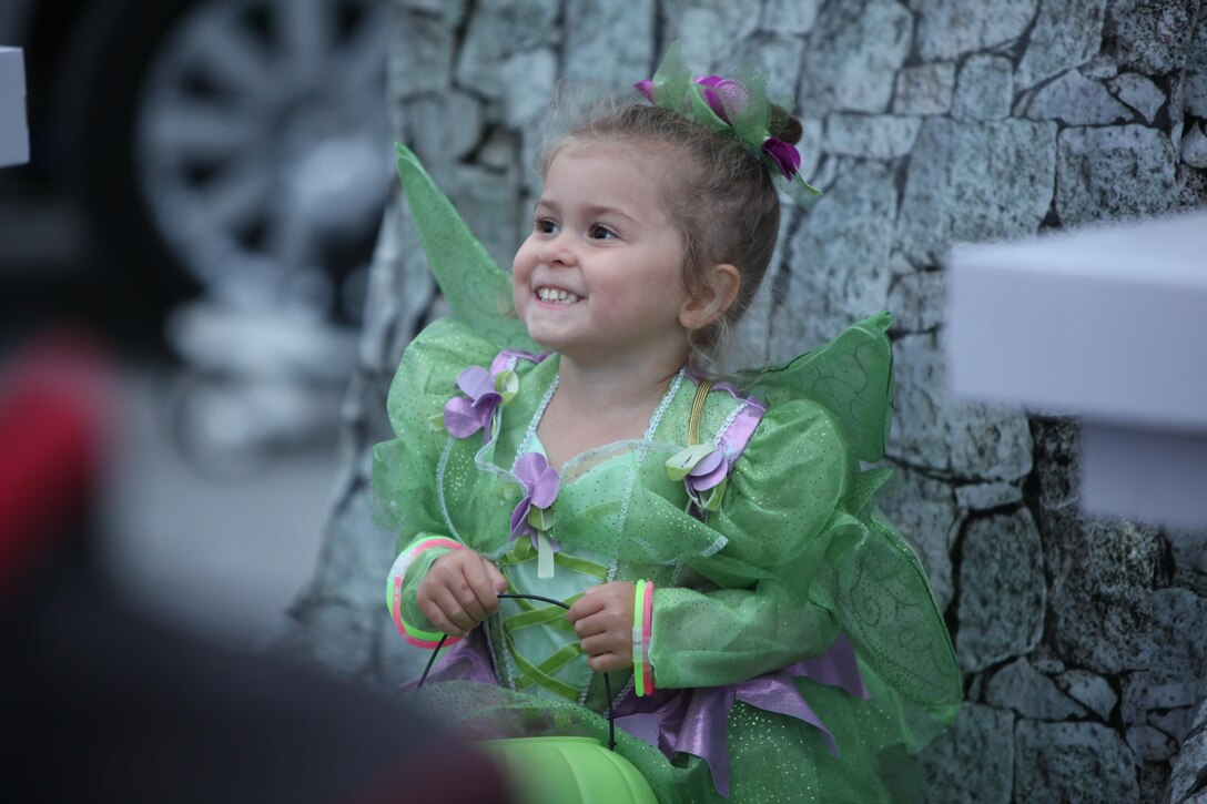 Noa, 3, smiles while receiving treats during the 3rd Annual Trunk-or-Treat event at Marine Corps Air Station Cherry Point, N.C., Oct. 26, 2015. Marine Wing Headquarters Squadron 2 and Marine Aircraft Group 14 hosted the event to increase camaraderie with the Marines and families of 2nd Marine Aircraft Wing. During the event, service members, spouses and family members were able to trick-or-treat, watch movies, get their face painted and play Halloween themed games. (U.S. Marine Corps photo by Cpl. U. B. Roberts/Released.)