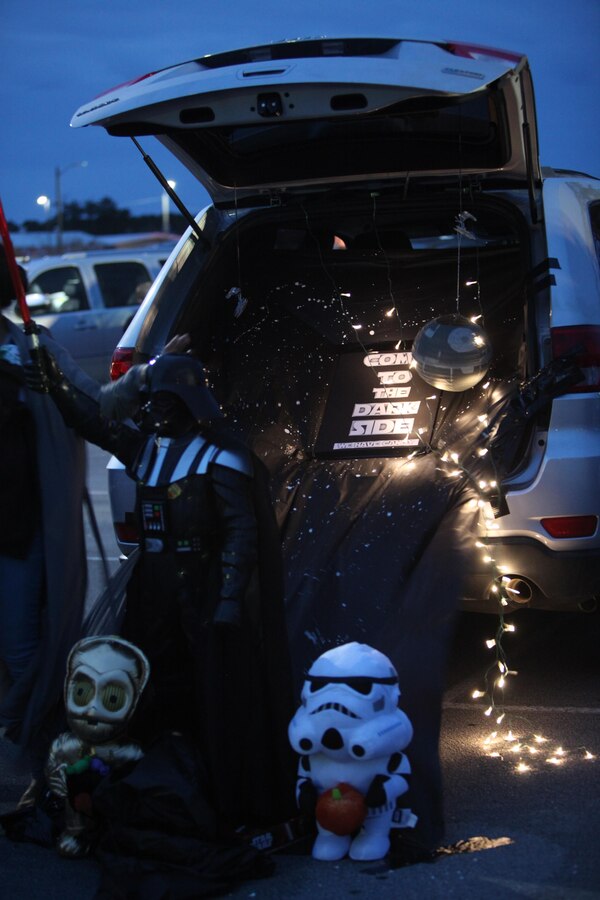Families with Marine Aircraft Group 14 and Marine Wing Headquarters Squadron 2 decorated the trunk of their vehicle for the 3rd Annual Trunk-or-Treat event at Marine Corps Air Station Cherry Point, N.C., Oct. 26, 2015. Families transformed the trunks of their vehicles into replicated hit movies for exciting themes like “Star Wars,” “Alice and Wonderland” and “It’s the Great Pumpkin: Charlie Brown.” During the event, service members, spouses and family members played games, watched Halloween movies and trick-or-treat. The event was hosted by Marine Wing Headquarters Squadron 2 and Marine Aircraft Group 14 family readiness officers to encourage families to come together in a safe and fun environment to trick-or-treat. (U.S. Marine Corps photo by Cpl. U. B. Roberts/Released.)