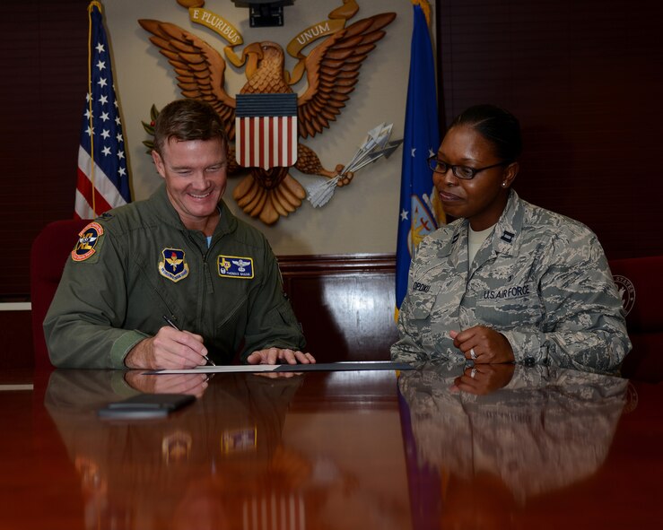 Col. Thomas Shank, left, 47th Flying Training Wing commander, signs the Combined Federal Campaign proclamation on Laughlin Air Force Base, Texas, Oct. 9, 2015. Every fall, federal employees are given the opportunity to donate money to thousands of charities in support of international, national and local health, welfare and service agencies.  (U.S. Air Force photo by Airman 1st Class Ariel D. Partlow)(Released)