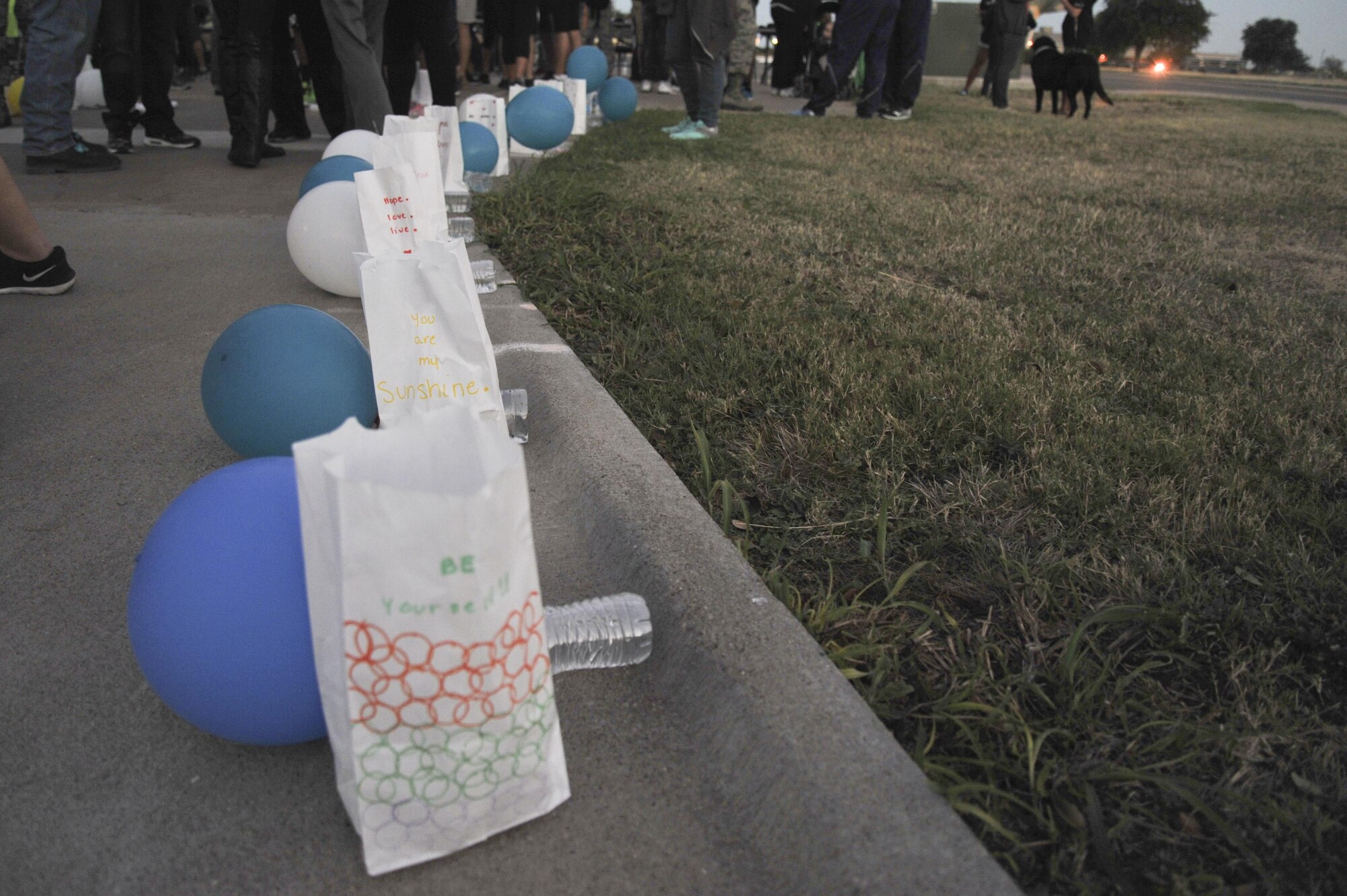 Paper bags and balloons represent sexual assault victims at the Sexual Assault Prevention and Response program’s Silent Glow Walk on Goodfellow Air Force Base, Texas, Oct. 27, 2015. Each bag represents a past sexual assault case at Goodfellow Air Force Base. (U.S. Air Force photo by Airman Chase Sousa/Released)