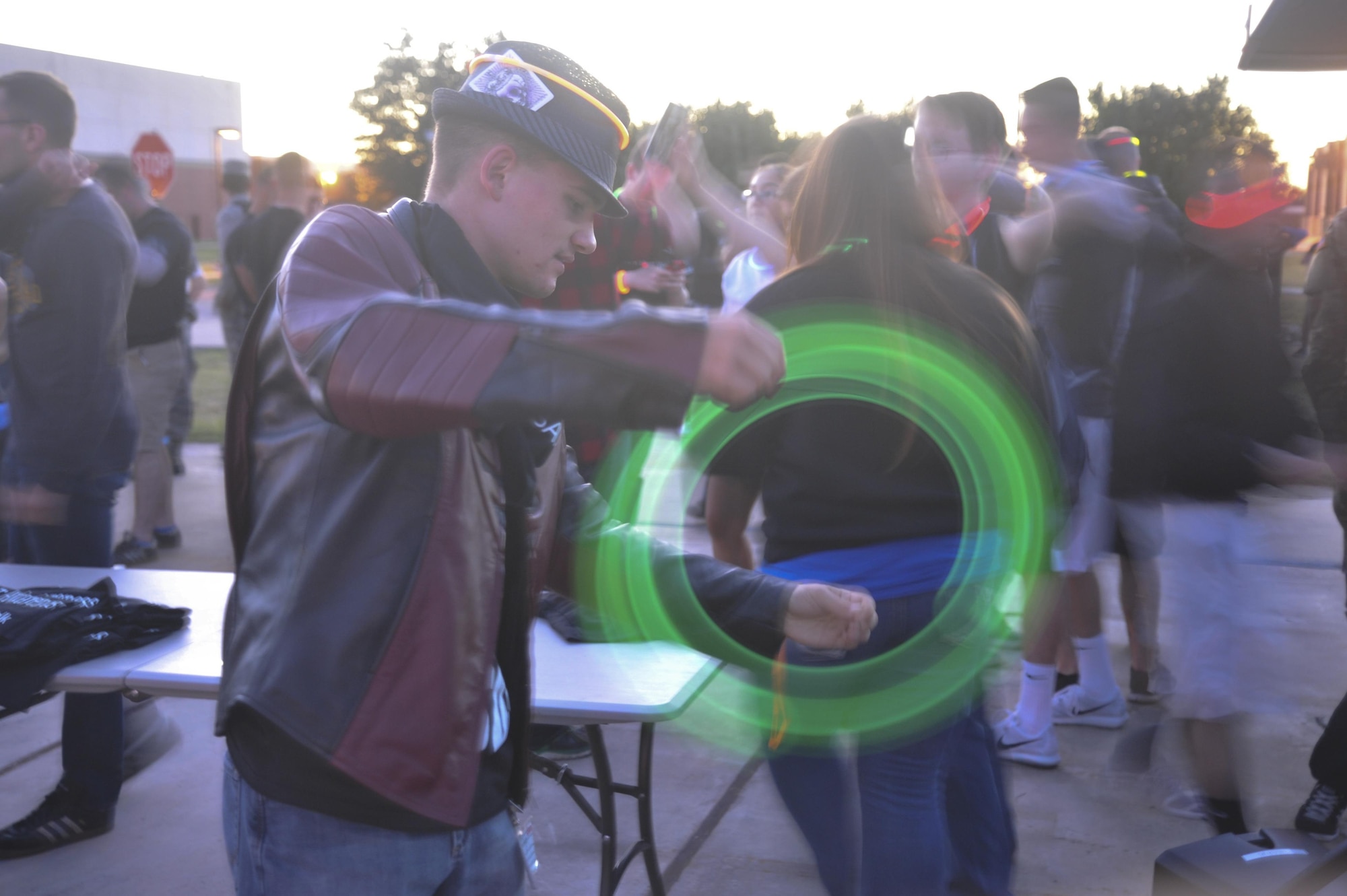 U.S. Air Force Airman 1st Class Brian D. Hier, 315th Training Squadron student, spins a glow stick on a string at the Sexual Assault Prevention and Response program’s Silent Glow Walk on Goodfellow Air Force Base, Texas, Oct. 27, 2015. The Glow Walk is an event to raise awareness for the SAPR program. (U.S. Air Force photo by Airman Chase Sousa/Released)