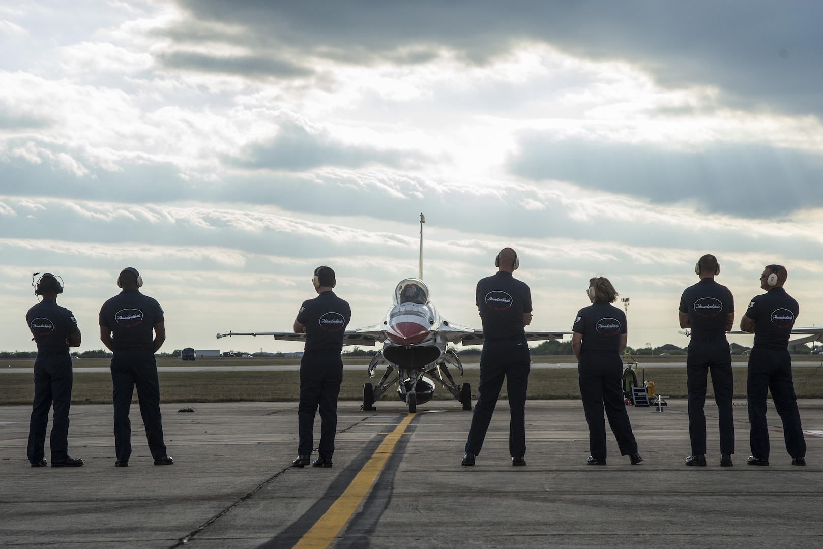 Members of the Thunderbirds ground crew wait to launch Maj. Scott Petz, Thunderbird #8, and Becky Hammon, San Antonio Spurs assistant coach, Oct. 29, 2015, at Joint Base San Antonio-Randolph. The Thunderbirds will be performing at the JBSA Air Show and Open House Oct. 31 and Nov. 1 at 3 p.m. Opening ceremonies are at 11 a.m. both days.  Go to www.jbsa.mil for more information on the two-day event that is free and open to the public.