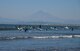 People surf in Sagami Bay in Fujisawa City, Japan, Oct. 25, 2015. Sagami Bay uses the Kuroshio Current to warm the bay, allowing it to host marine organisms typical of more southerly regions and giving a mild climate to the land bordering it. (U.S. Air Force photo by Senior Airman David Owsianka/Released)