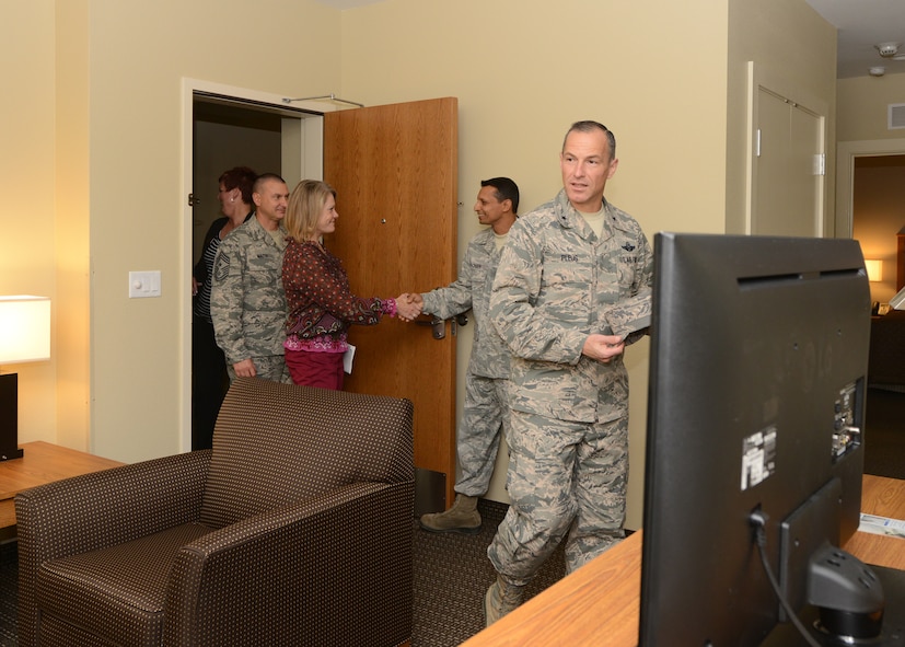 Brig. Gen. Scott Pleus, 56th Fighter Wing commander, Jennifer Pleus, and Chief Master Sgt. John Mazza, 56th FW command chief, tour a lodging room October 29, 2015, at Luke Air Force Base, Arizona. The rooms feature a living room, dining room, kitchen, in-house washer and dryer and bathroom. There are two bedrooms, one with a queen bed and the other with two twin beds. The front room couch features a pull out full bed and every room comes equipped with a pack & play crib. (U.S. Air Force photo by Staff Sgt. Marcy Copeland)     