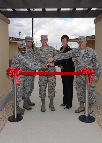 Brig. Gen. Scott Pleus, 56th Fighter Wing commander, Col. James Pease, Air Education Training Command director, manpower, personnel, and services, Col James Kossler, 56th Mission Support Group commander, Maj. Tonya Mack, 56th Force Support Squadron commander, and Jane Yates, 56th FSS lodging manager, pose for a photo October 29, 2015, at Luke Air Force Base, Arizona. Pleus and others in attendance came out for the official ribbon cutting ceremony of the new lodging facility at Luke. (U.S. Air Force photo by Staff Sgt. Marcy Copeland)    