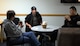 Debbie Ellgen, Higher Grounds Airmen Ministry Center co-director speaks with Airmen after dinner Oct. 28, 2015, in the center located in Bldg. 248 on F.E. Warren Air Force Base, Wyo. Ellgen cooks dinners for Airmen three times a week to help foster a family-like community in the center. (U.S. Air Force photo by Senior Airman Brandon Valle)