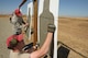 Combat Arms Training and Maintenance Instructors, 129th Security Forces Squadron, California Air National Guard checks a target for proper sight alignment during a weapons qualification training, Beale Air Force Base, Calif., Oct. 10, 2015. The training is in preparation for a future deployment.  (U.S. Air National Guard photo by Kim E. Ramirez/Released)