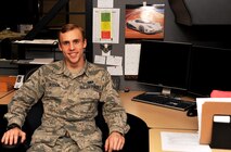 Airman 1st Class Levi Jackson, 319th Comptroller Squadron financial services technician, poses for a photo at his workspace on Grand Forks Air Force Base, North Dakota, Oct. 29, 2015. Jackson was named Warrior of the Week for the fifth week in October. (U.S. Air Force photo by Airman 1st Class Bonnie Grantham/released)