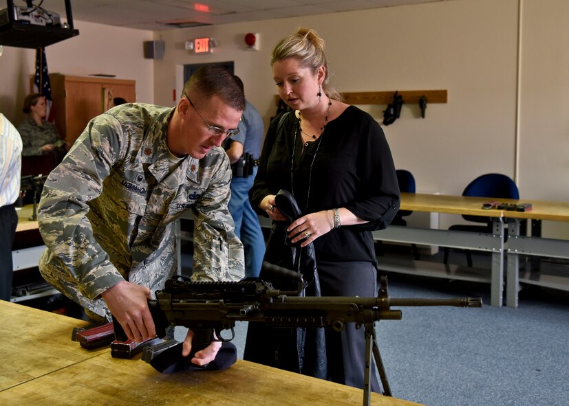 Maj. Kevin McMahon, 92nd Security Forces Squadron commander, speaks with Jessica Kirk, Greater Spokane Incorporated procurement technical assistance center manager, during an honorary commander’s tour Oct. 27, 2015, at Fairchild Air Force Base, Wash. The program helps community leaders learn the importance of the missions at the base, and get to know the Airmen who execute them. (U.S. Air Force photo/Airman 1st Class Taylor Bourgeous)
