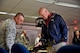 Staff Sgt. Caleb Myers, 92nd Security Forces Squadron combat arms instructor, answers questions asked about the M4 Carbine from Todd Kiesbuy, Regional Business Manager with Avistia Utilities, during an honorary commander’s tour Oct. 27, 2015, at Fairchild Air Force Base, Wash. The honorary commanders program brings together leaders from the military and civilian communities together in an informal program designed to continue to raise mutual understanding and establish bonds of friendship. (U.S. Air Force photo/Airman 1st Class Taylor Bourgeous)