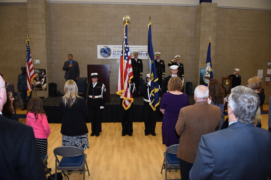 Sailors of Navy Operational Support Center - Pittsburgh and guests stand for the presentation of the colors during a change of command ceremony at the Pittsburgh International Airport Air Reserve Station, Oct. 3, 2015. Cmdr. Craig Frangente relinquished command to Cmdr. Donald G. Haley. (U.S. Air Force photo by Senior Airman Marjorie A, Bowlden)